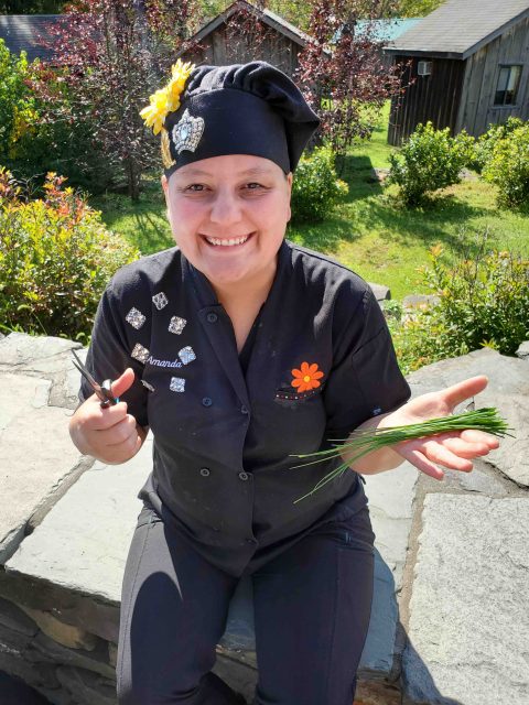 Chef Amanda snips herbs from her garden.